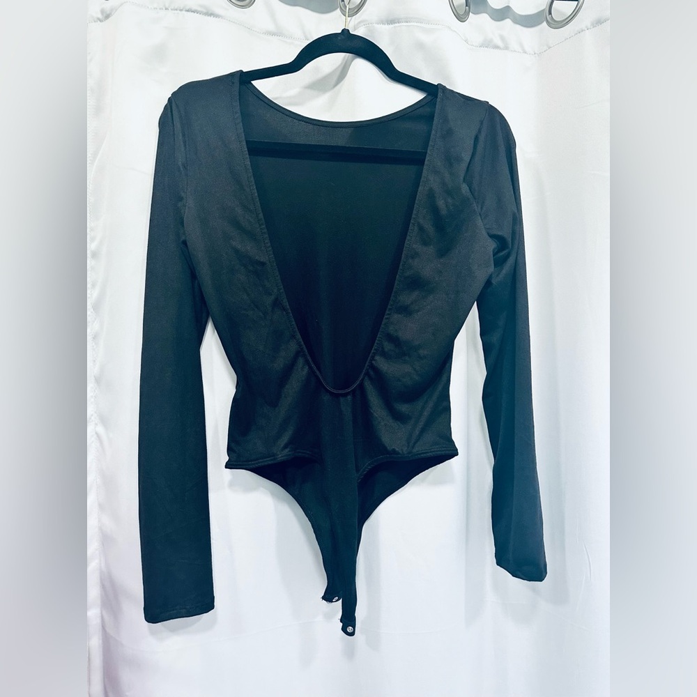Black, Size med (fits like a small) long sleeve open scoop back bodysuit.